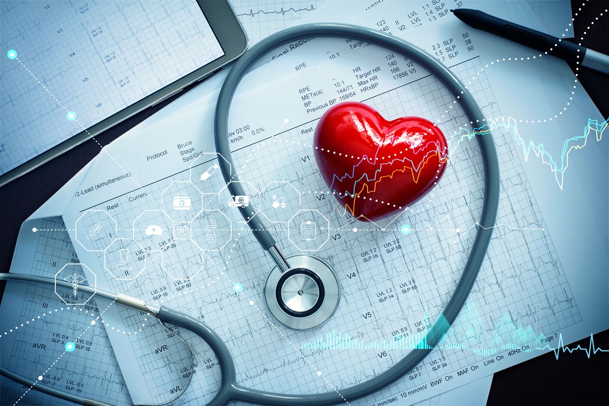 Red heart shape with stethoscope and patient heartbeat report