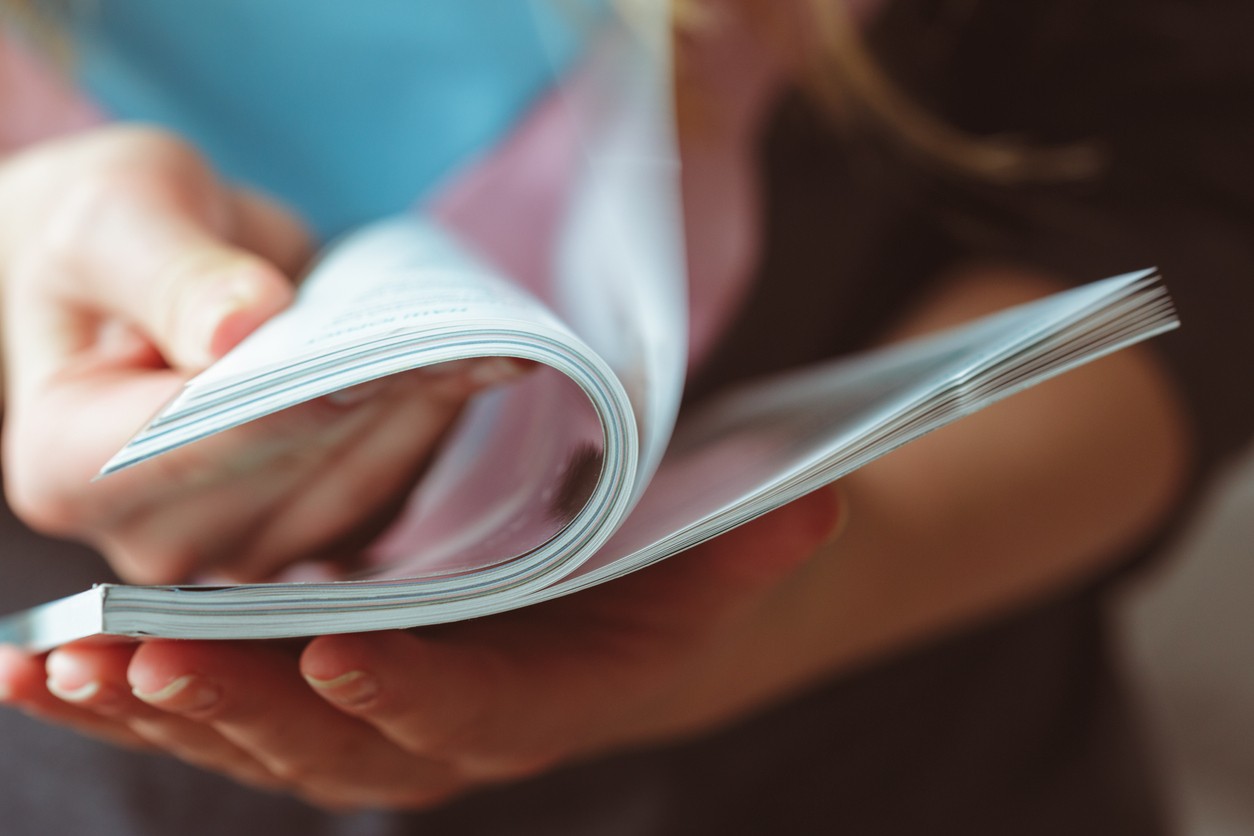 woman reading magazine at home